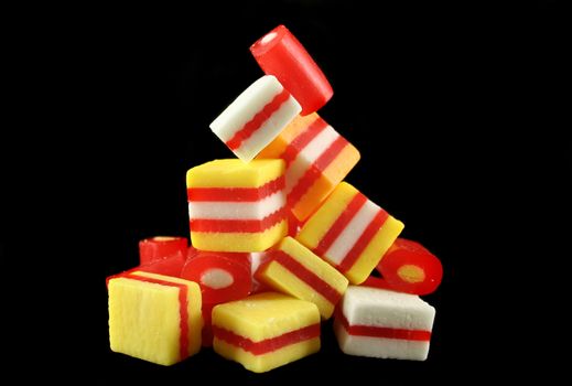Colorful striped fruit flavored candies ready to eat.