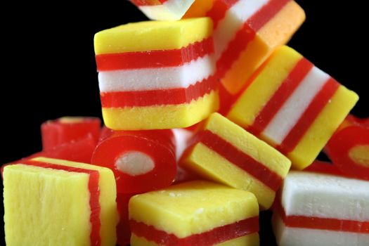 Colorful striped fruit flavored candies ready to eat.