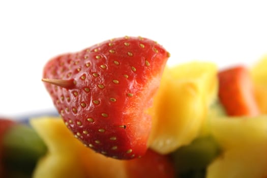 Colorful kebabs made with skewers of fresh fruit pieces.