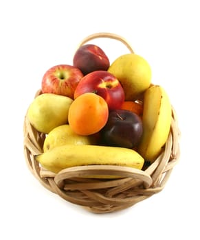 Cane basket filled with freshly picked colorful organic fruit.