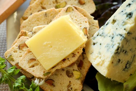Delicious fruit and cheese platter featuring a variety of different cheeses and fresh fruits.
