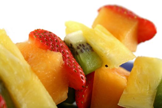 Colorful kebabs made with skewers of fresh fruit pieces.
