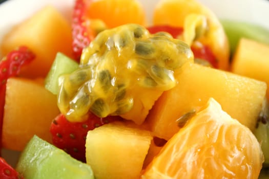 Delicious bowl of freshly picked fruit salad topped with passionfruit.