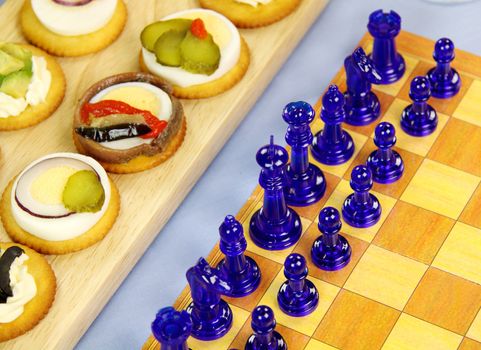 Finger food laid out with a game of chess for a games night.