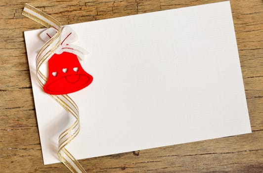 white paper background with Christmas bell on wood