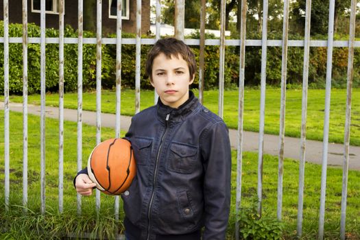 Portrait of serious boy street basket player