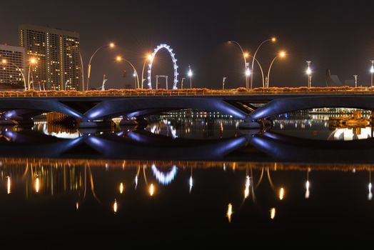 Singapore night skyline of the Esplanade bridge, theater and Singapore Flyer taken from the Esplanade park