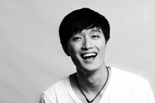 Portrait of young man laughing out loud, black and white style