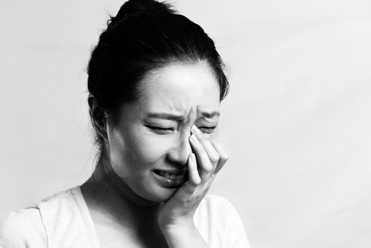 Portrait of pretty girl crying desperately, black and white style