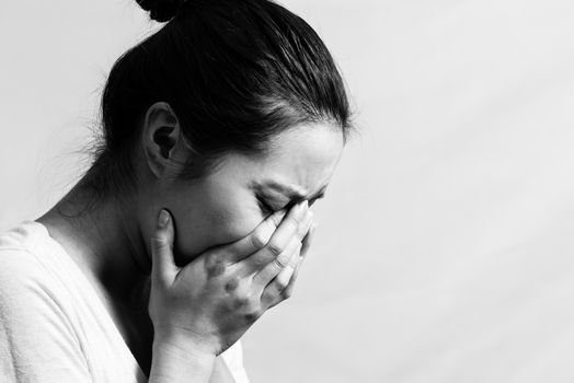 Portrait of pretty girl crying desperately, black and white style