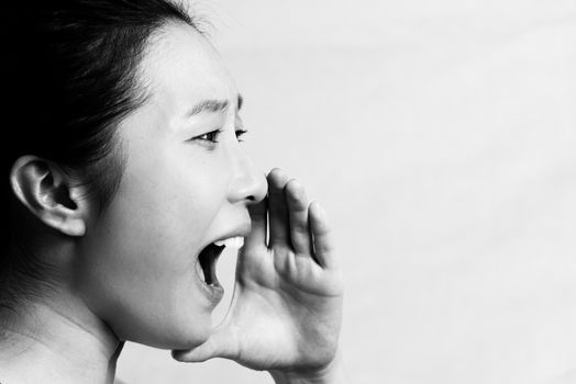 Portrait of young attractive girl yelling looking upset, black and white style