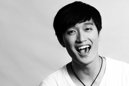 Portrait of young man laughing out loud, black and white style