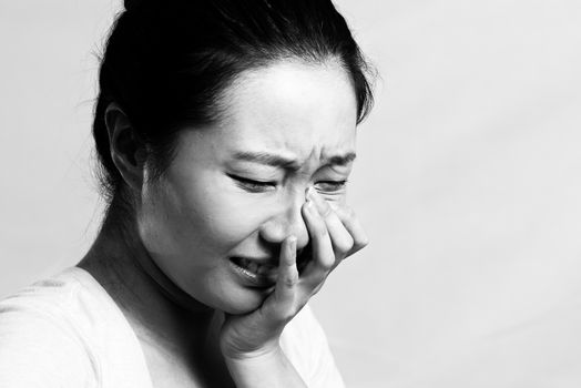 Portrait of pretty girl crying desperately, black and white style