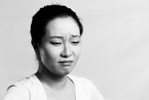 Portrait of pretty girl crying desperately, black and white style