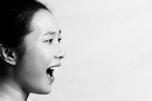 Portrait of young attractive girl yelling looking upset, black and white style
