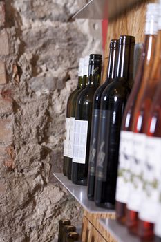 Wine bottles on a shelf in a wine shop 