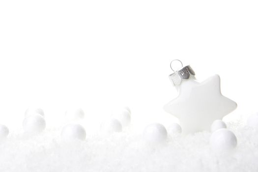 white christmas bauble as christmas star on snow 