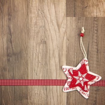 Christmas decoration with wood background, Christmas star red with ribbon 