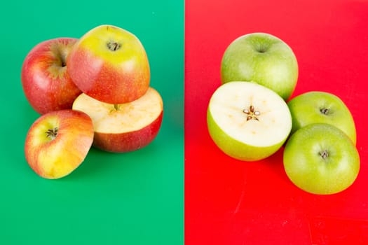 Red and green apple pieces on colored background