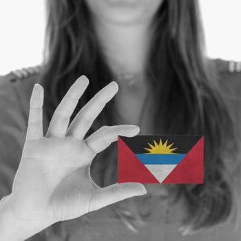 Woman showing a business card, flag Antigua and Barbuda