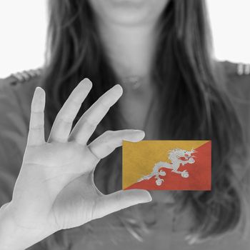 Woman showing a business card, flag of Bhutan