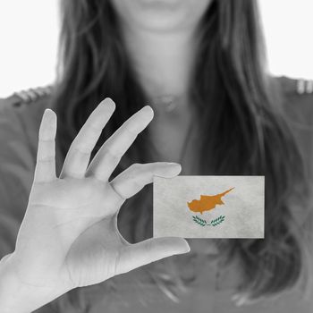 Woman showing a business card, flag of Cyprus