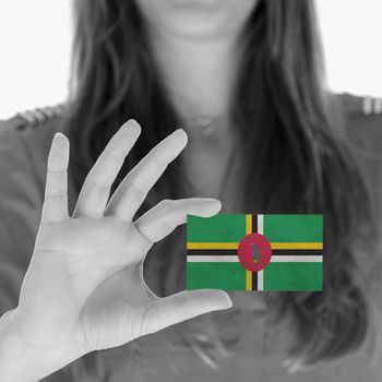 Woman showing a business card, flag of Dominica