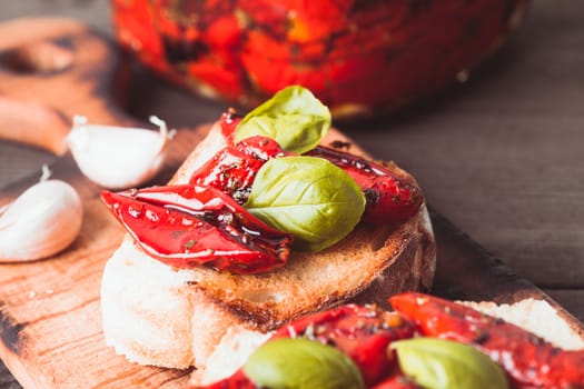 Bruschetta with sun dried tomatoes, basil leaves and garlic