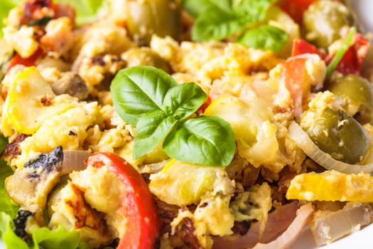 Omelet with vegetables and bacon on the plate