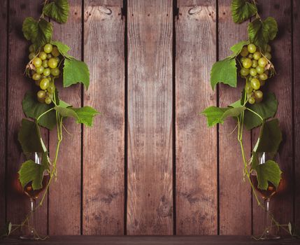 Grapes with leaves and glass of wine on the wood background