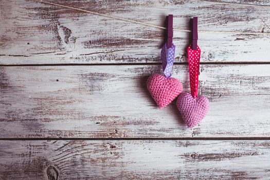 Crochet valentine hearts handing on the rope. Valentine's day greeting card. Love concept