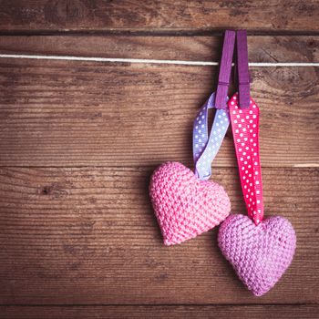 Crochet valentine hearts handing on the rope. Valentine's day greeting card. Love concept