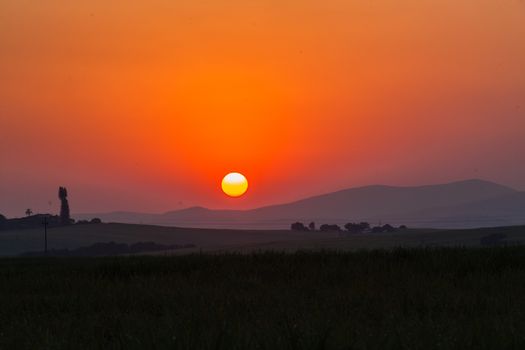 Sun setting over the scenic landscape on winters day