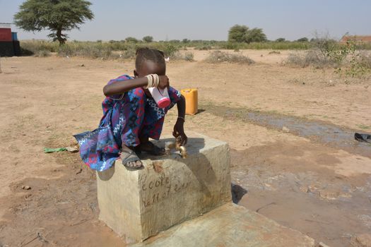 African child drinks water