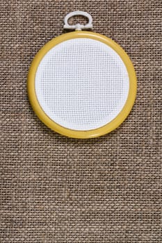 Hoop with a white canvas on a fabric background