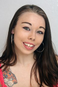 Headshot of a lovely young brunette with a bright, warm smile.