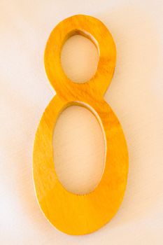 A wooden number 8 or eight is carved out of the wood at a wedding.