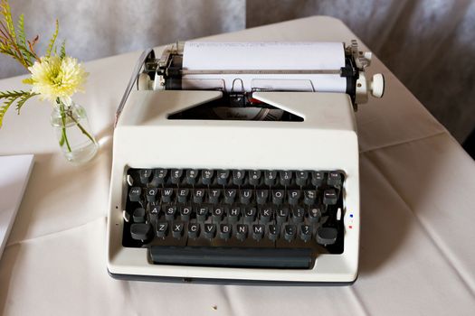 An antique typewriter is used as a guestbook at this wedding ceremony and reception.
