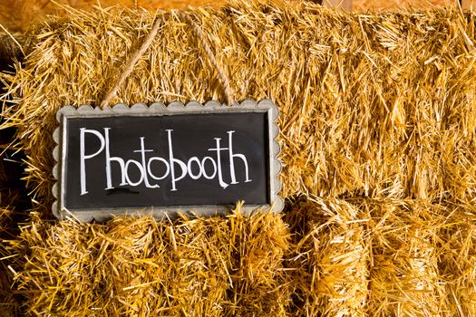 Decor at this wedding includes chalkboard signs that say photobooth or photo booth to indicate it's location at the reception.