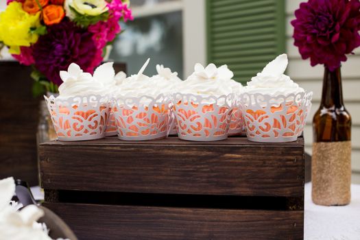 These cupcakes at a wedding reception are ready for the guests to enjoy after the cake cutting ceremony.