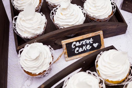 These cupcakes at a wedding reception are ready for the guests to enjoy after the cake cutting ceremony.