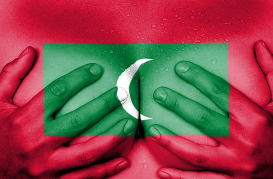 Sweaty upper part of female body, hands covering breasts, flag of Maldives