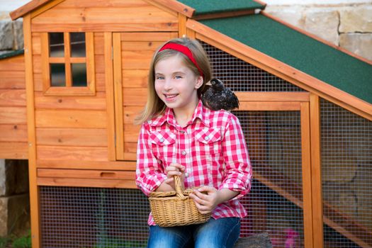 breeder hens kid girl rancher blond farmer playing with chicks in chicken tractor coop