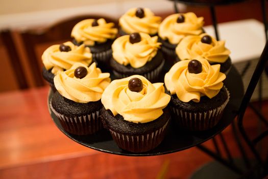 These cupcakes at a wedding reception are ready for the guests to enjoy after the cake cutting ceremony.