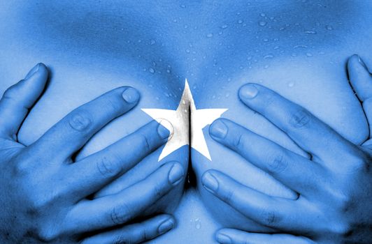 Sweaty upper part of female body, hands covering breasts, flag of Somalia