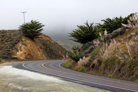 Road in the fog, leading to Half Moon Bay, California