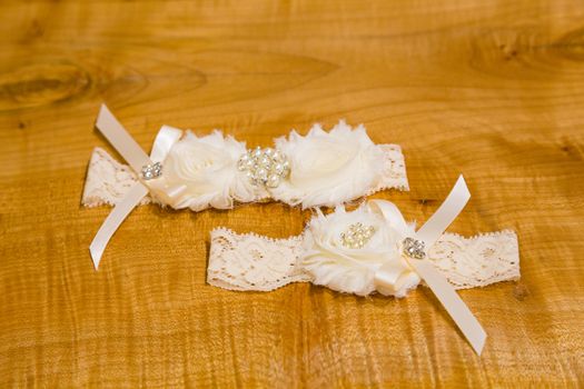 A white garter ready for the bride to put on before the garter toss on her wedding day.