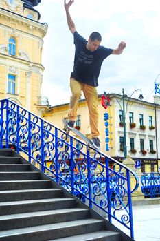 Krakow, Poland - August 26, 2013: Teenager skateboarder is practicing and performing jump tricks on stairs in Krakow, Poland. 