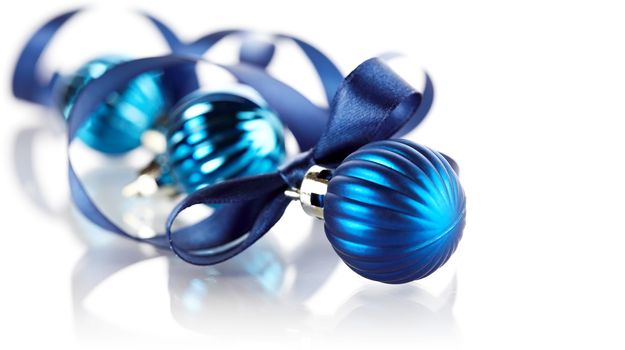 New Year's balls. Christmas tree decorations. New Year's blue balls with a blue satin ribbon.