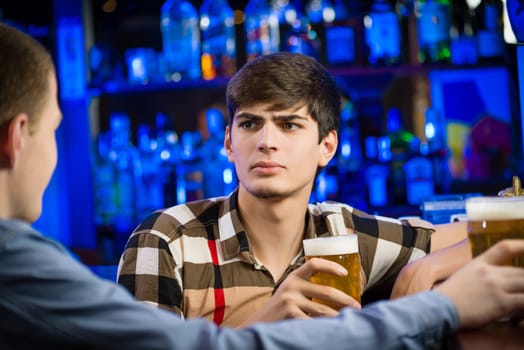 portrait of a young man at the bar, spending time in a nightclub